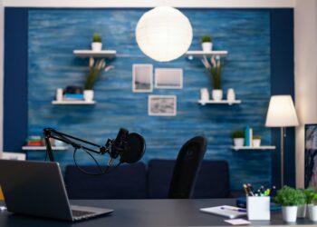 Empty podcast studio with nobody in it equipped with professional production podcasting equipment