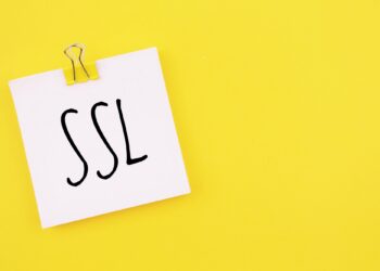 Note written on a white sticker with paper clip on a yellow background . Inscription SSL