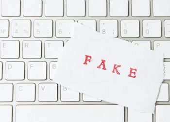 Word Fake written on torn paper